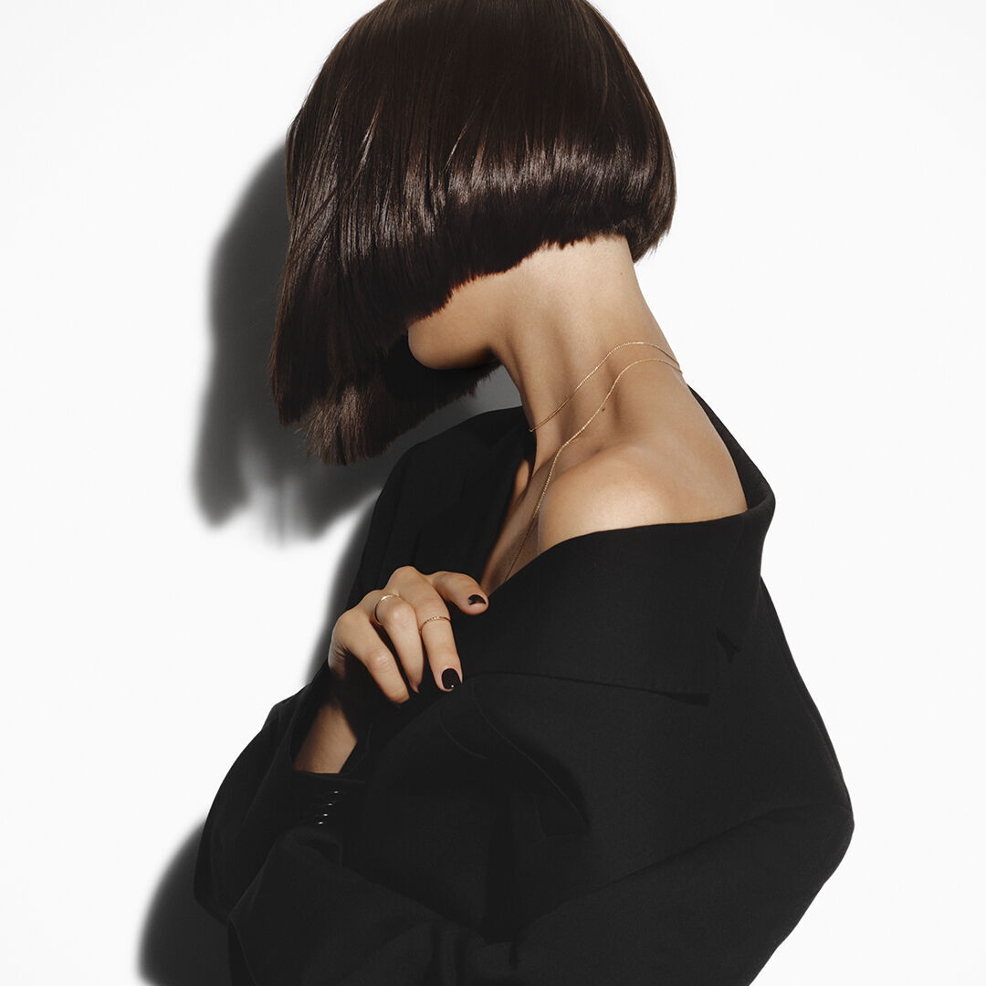 Woman with a sleek, short brunette bob hair cut.