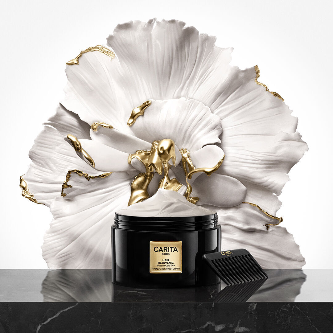 Hair Rejuvenic Restructuring Radiance Mask in front of a flower.
