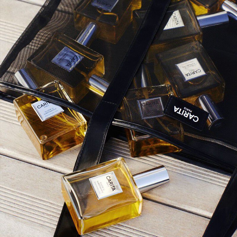 Carita, the art of high beauty. An immaculate box, adorned with an elegant black ribbon, reveals an exquisite selection: OR REJUVENIC serum, Obsidian Renovator, and precious creams. A promise of excellence for sublimated skin.​