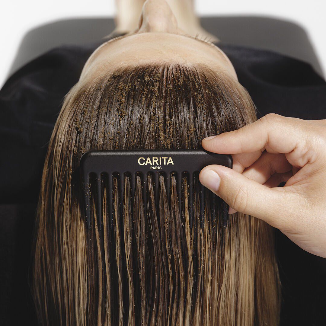 Comb Carita through the hair with Le Renovateur scrub.