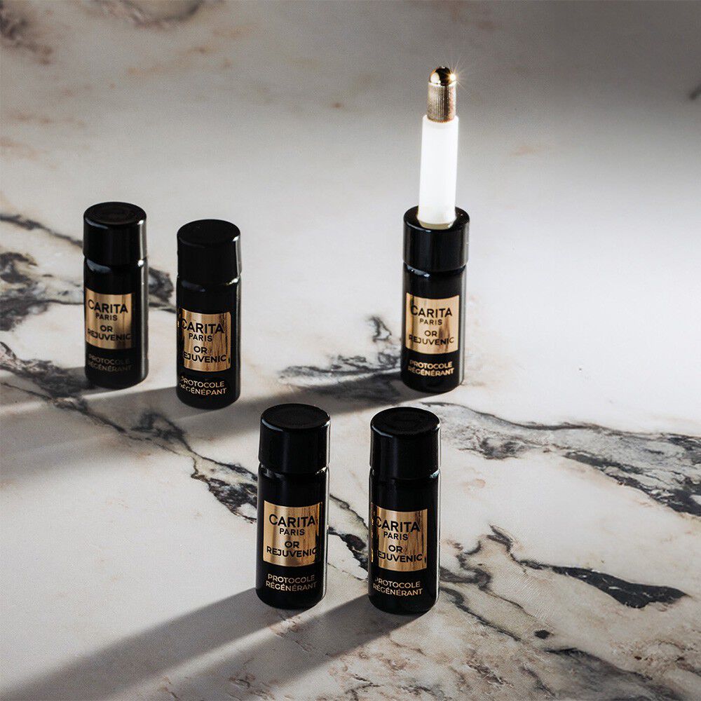 Carita Or Rejuvenic ampoule treatment on a luxurious marble surface.