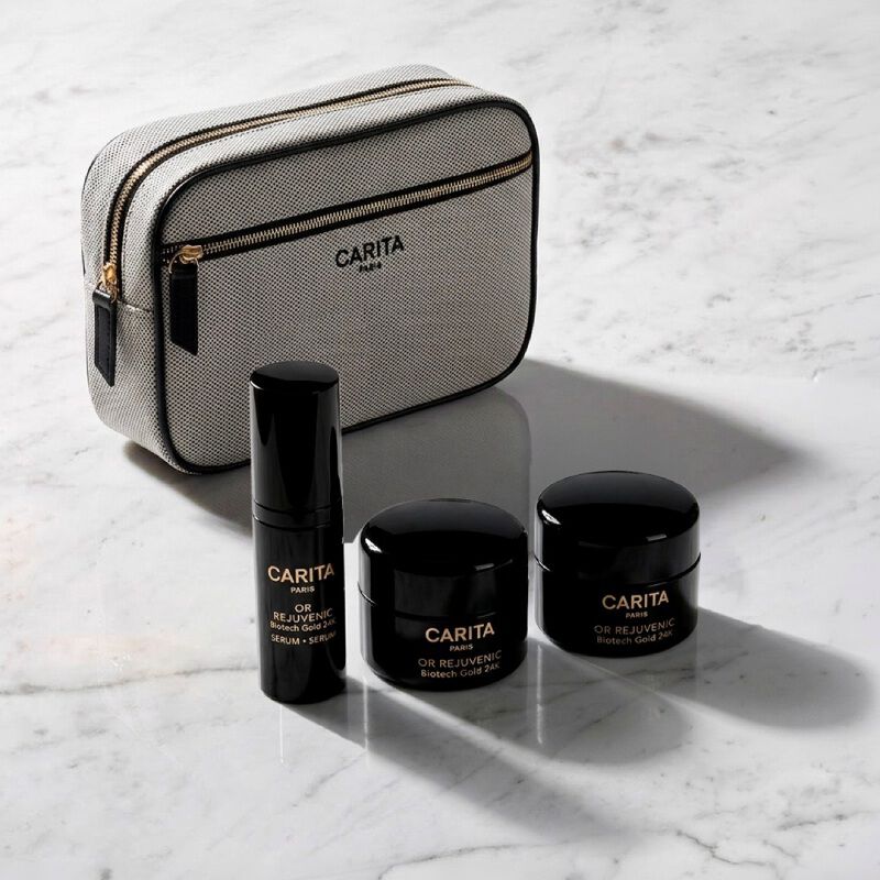 Carita skincare bag and three Or Rejuvenic black product jars.