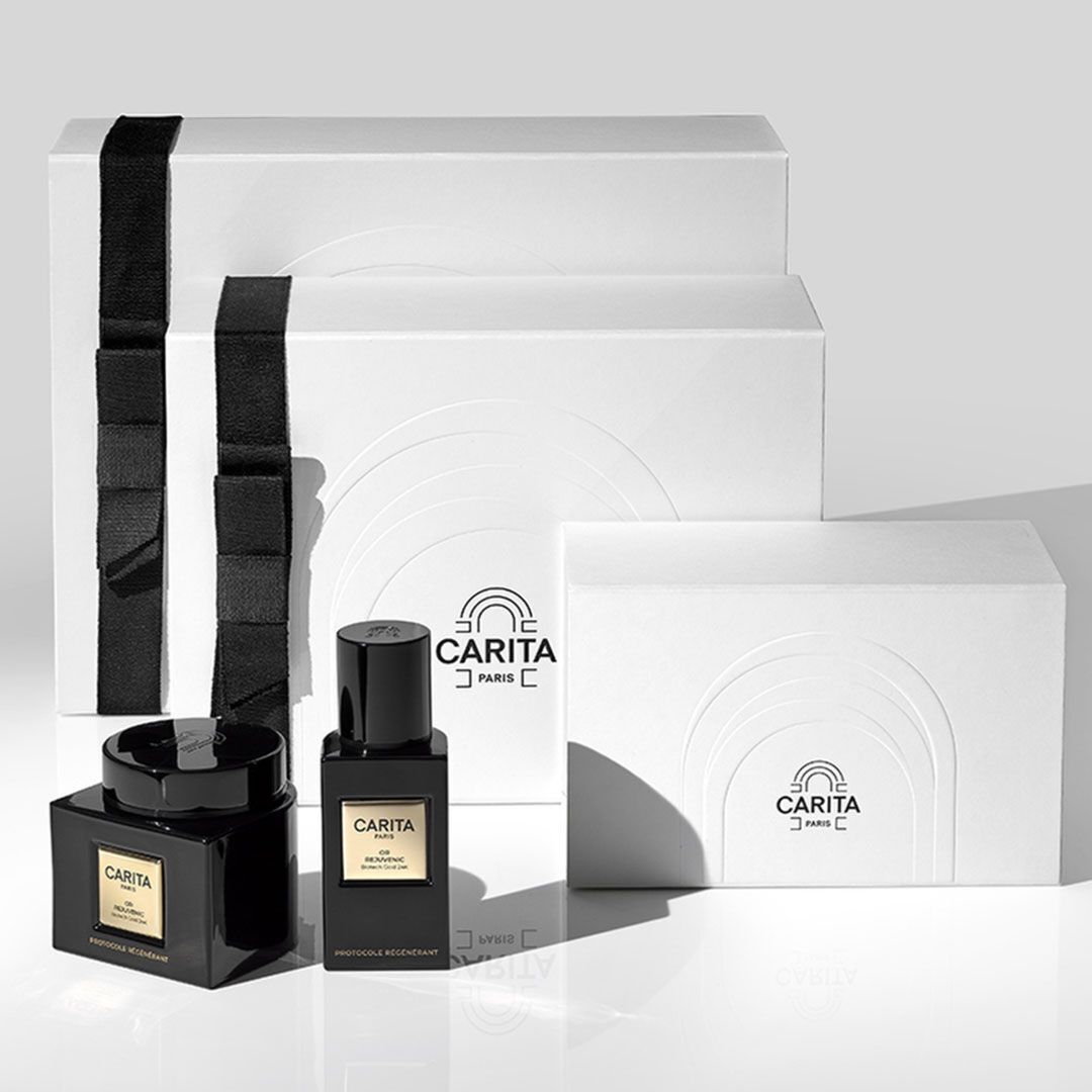 Row of white gift boxes and black Carita bottles.