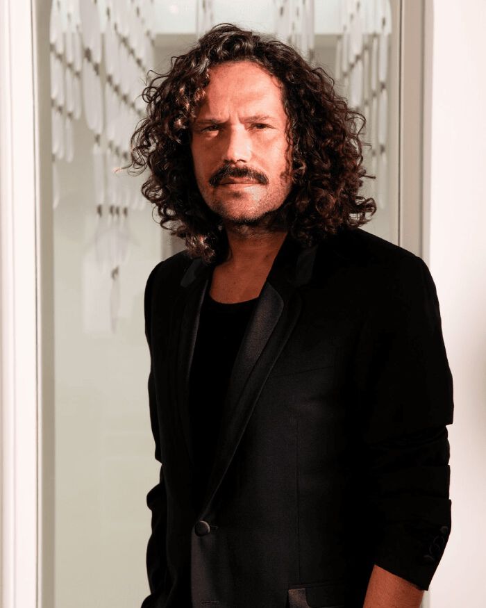 Smiling portrait of hair ambassador David Lucas in a suit.