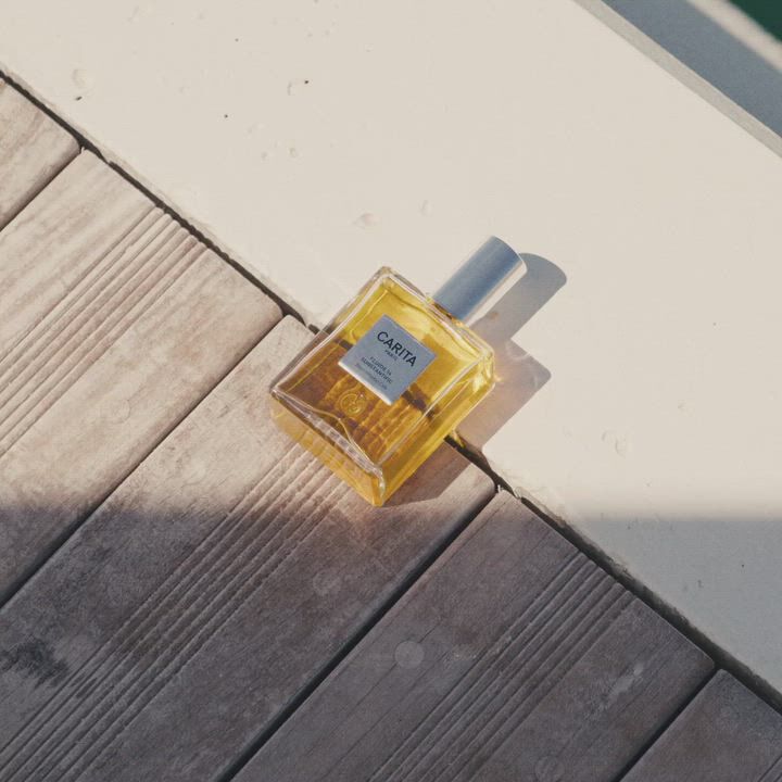 Applying Carita Fluide 14 oil whilst facing the sea.