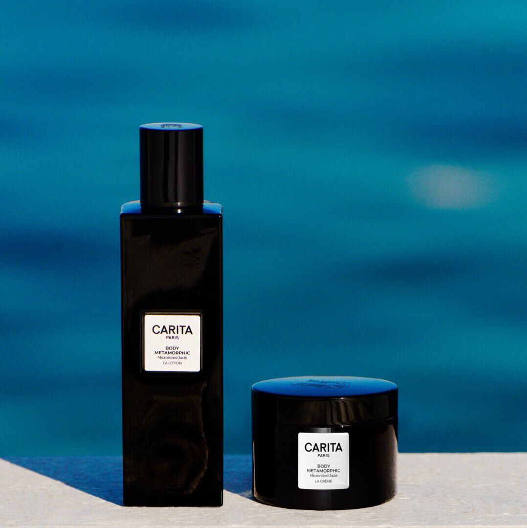 Black Carita Body Metamorphic bottle and jar against a black background.