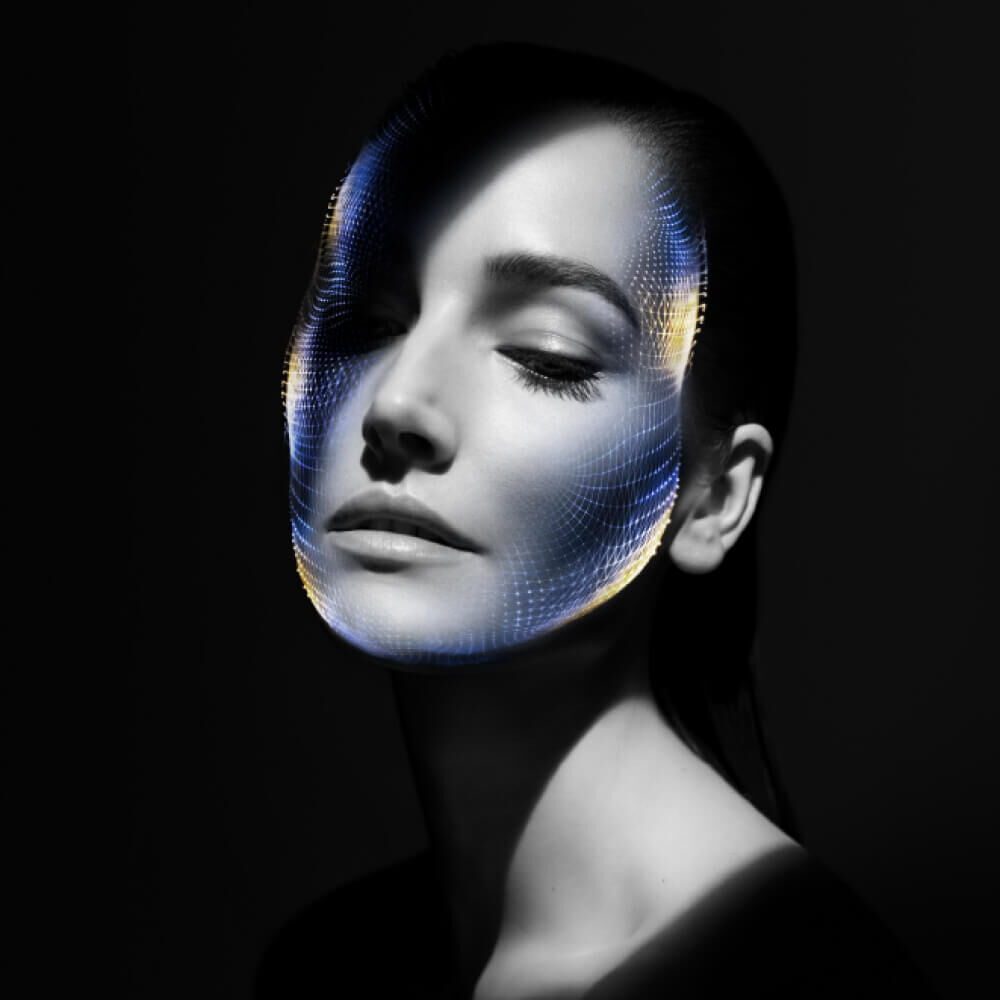 Dramatic portrait with a blue digital tech grid over the face.