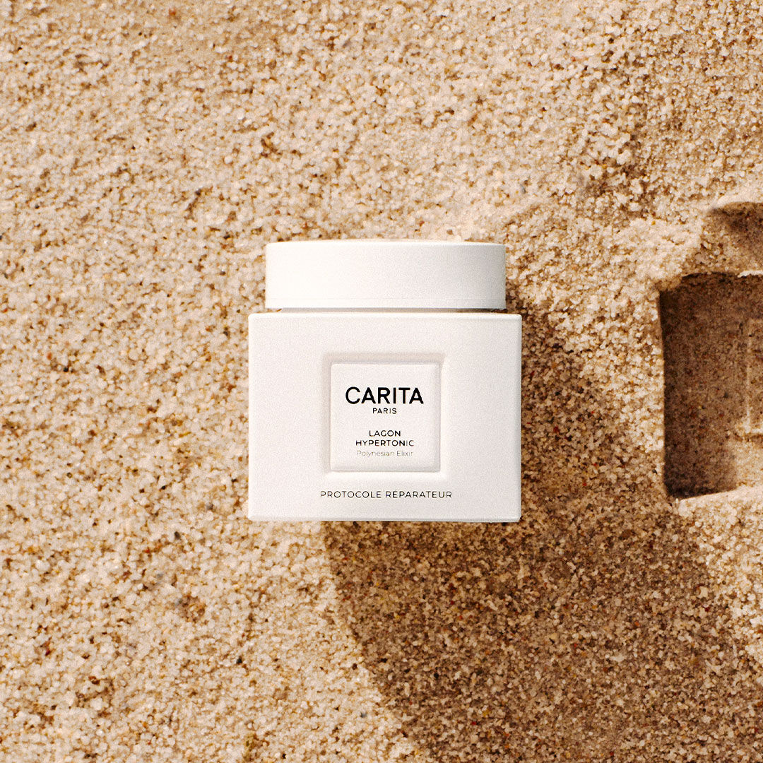 White Lagon Hypertonic balm jar placed on fine sand.