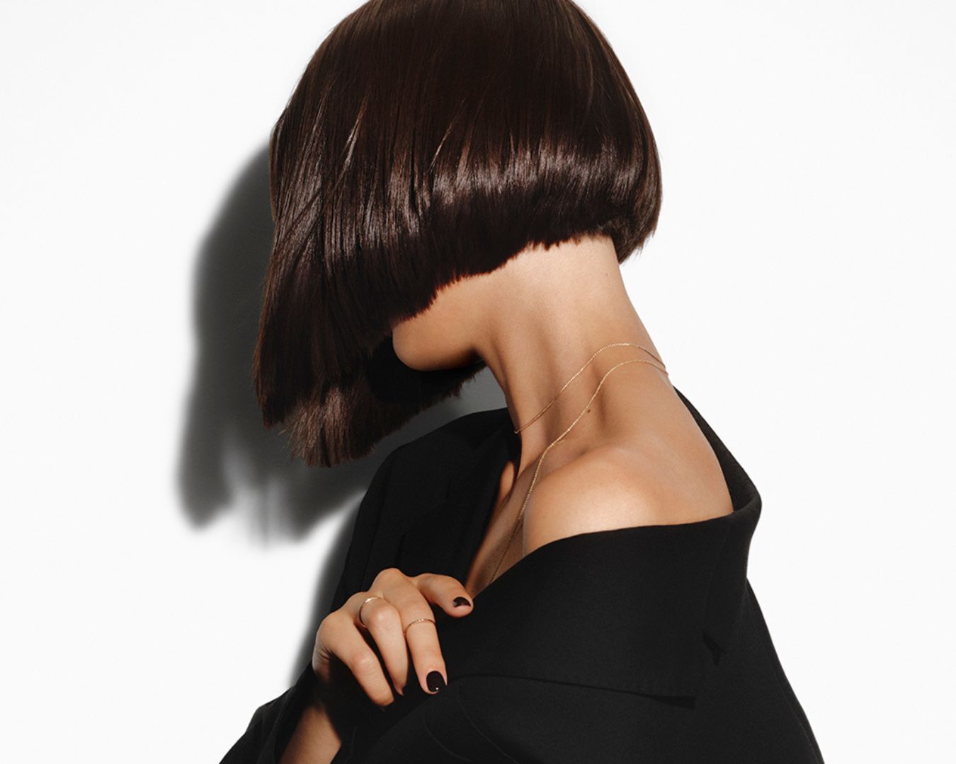 A brunette woman with short, straight, bob-cut brown hair.