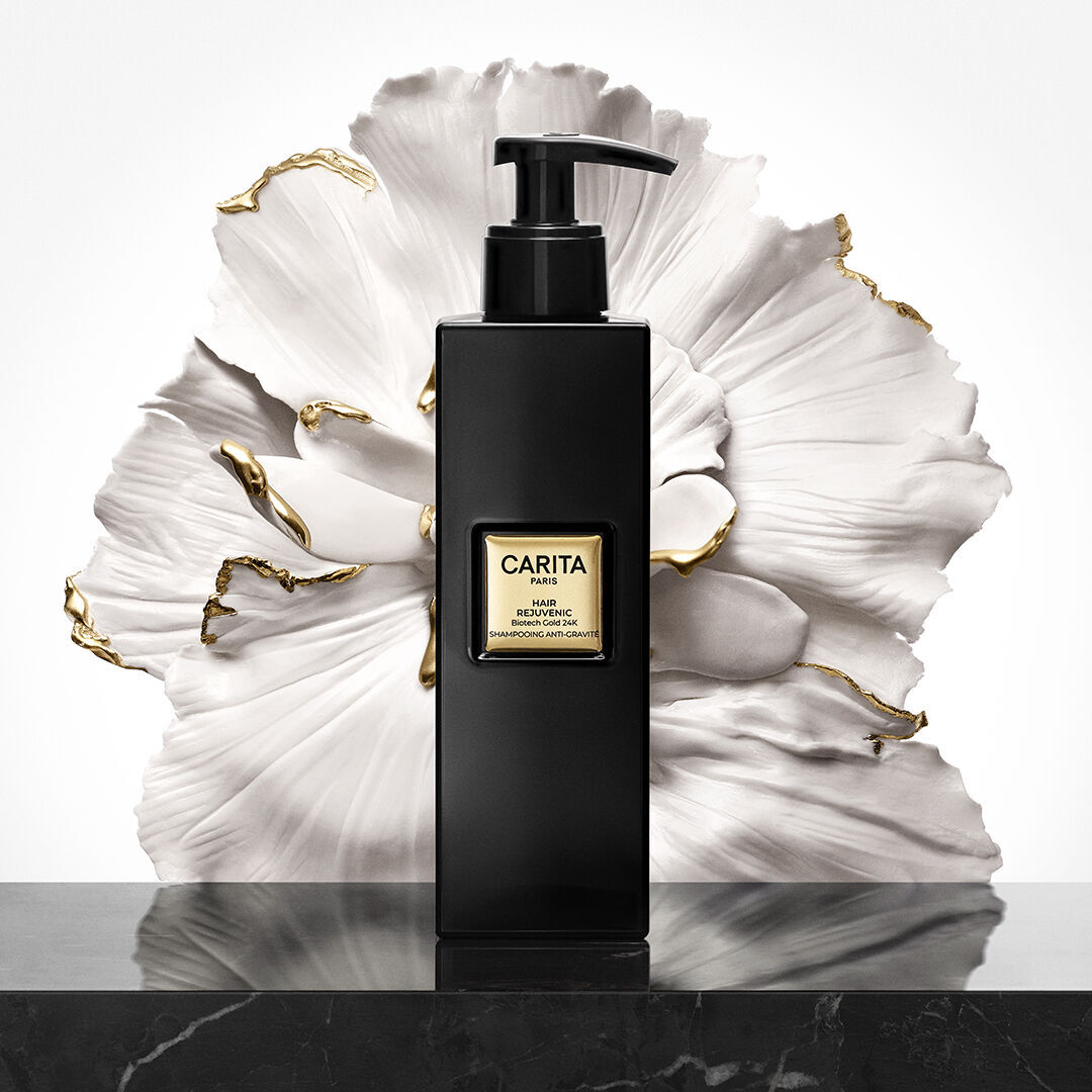 Hair Rejuvenic Anti-Gravity Shine Shampoo, pictured in front of a flower.