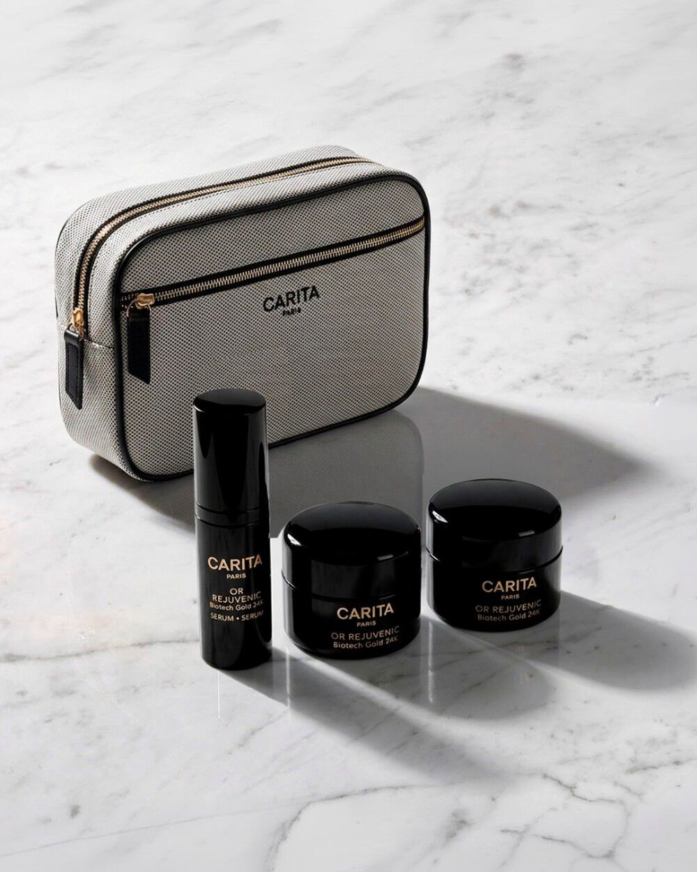 Carita Or Rejuvenic gift set: grey bag and 3 skincare products.