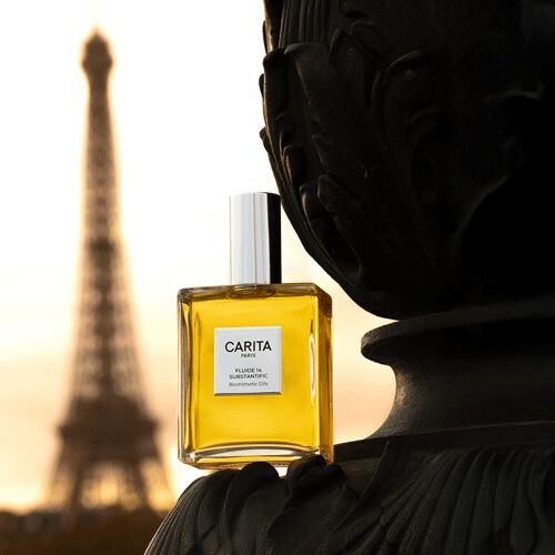 Carita "Or Rejuvenic" product on marble base, with an abstract golden form evoking gold in the background. Luxurious and artistic presentation.